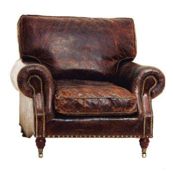 A traditional brown leather armchair with rolled arms, stud detailing and castors on the chair feet.